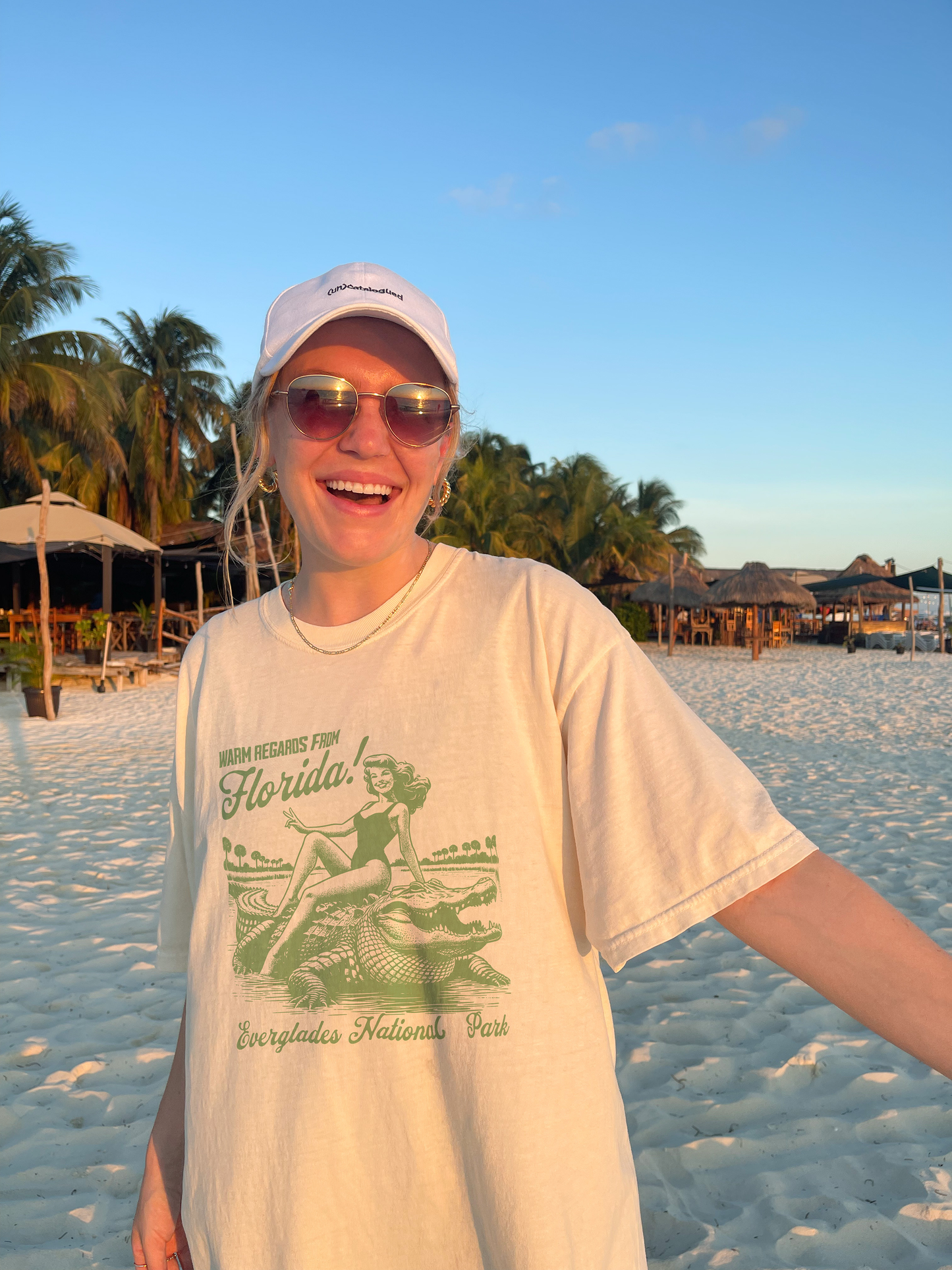 Woman wearing vintage-style Florida Everglades National Park graphic tee on a beach at sunset – relaxed fit Comfort Colors shirt with granola girl aesthetic.