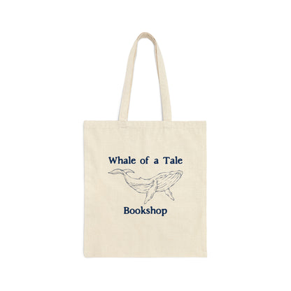 A canvas tote bag with a navy blue DTG graphic that features a whale and reads "Whale of a Tale Bookshop"