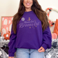 Crewneck sweatshirt with a simple witch and full moon graphic and retro inspired font that reads Moons out Brooms out in purple.