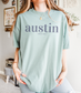 A Comfort Colors TShirt with a simple text graphic that reads austin since 1839 inspired by Austin, Texas