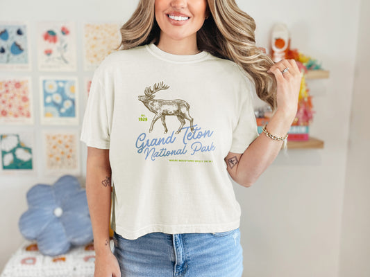 Model wearing cropped Comfort Colors t-shirt with vintage elk and “Grand Teton National Park” text – granola girl aesthetic shirt