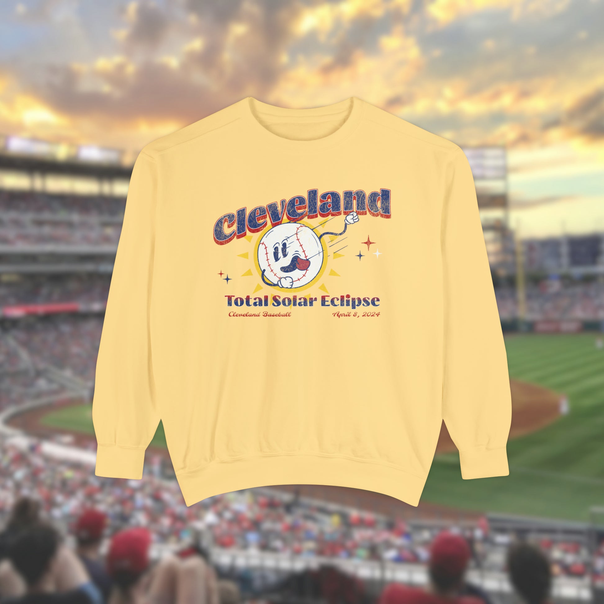 Pastel Yellow Comfort Colors Crewneck Sweatshirt with a retro vintage inspired baseball character mascot. The text reads Cleveland Total Solar Eclipse CLE baseball April 2024