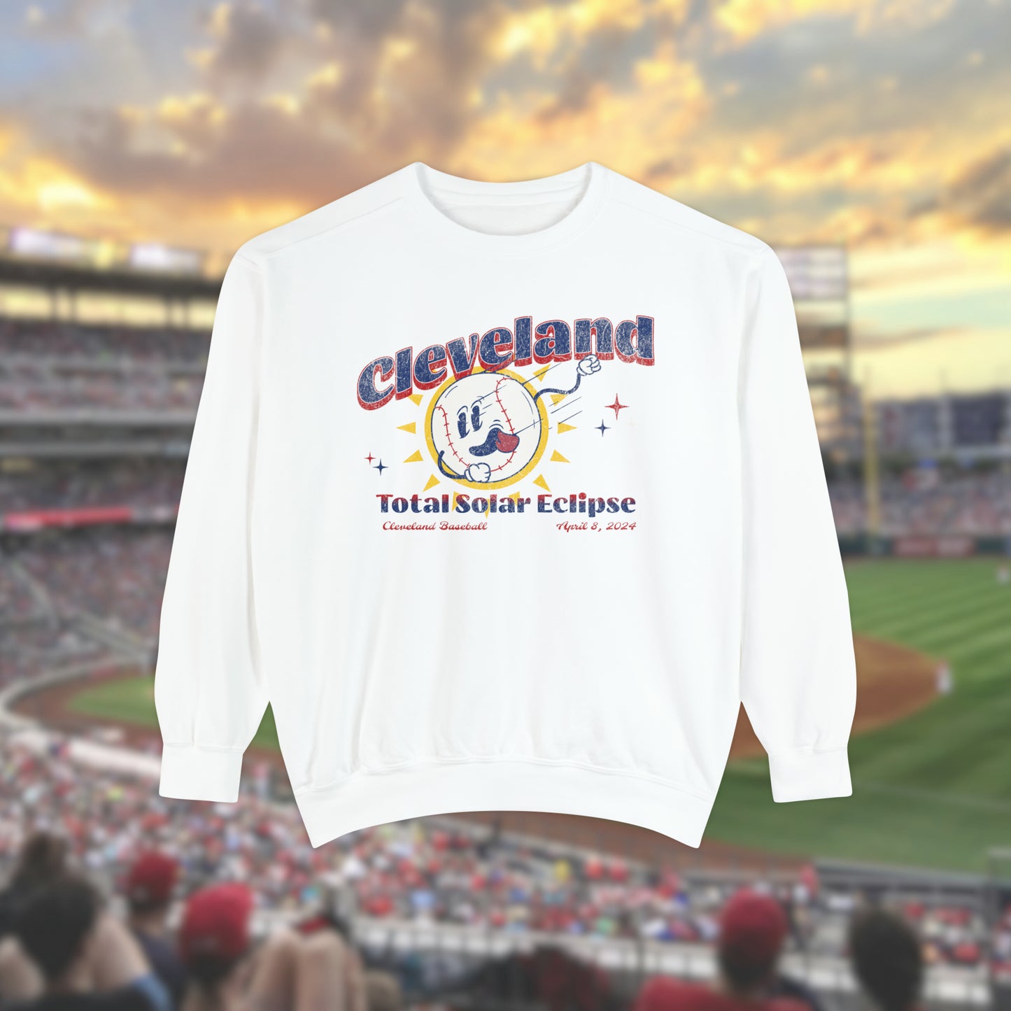 White Comfort Colors Crewneck Sweatshirt with a retro vintage inspired baseball character mascot. The text reads Cleveland Total Solar Eclipse CLE baseball April 2024