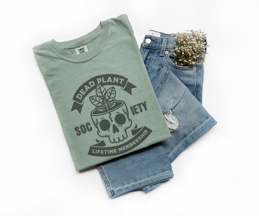 a "bay" Comfort Colors t-shirt with skull planter graphic and “Dead Plant Society – Lifetime Membership” text – funny vintage tee for plant killers