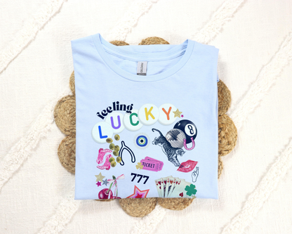 Feeling Lucky collage graphic t-shirt with retro-inspired icons – includes 8-ball, cherries, dice, lips, tiger, and stars. Gildan 6400 tee in trendy preppy Y2K style.