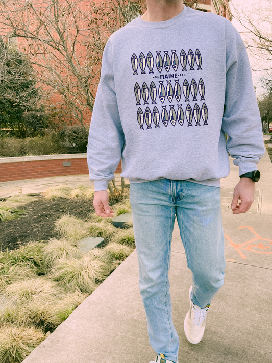 Model wearing Maine fish sweatshirt in a natural setting – soft and comfy crewneck for cabin mornings, hiking, and outdoor adventures.